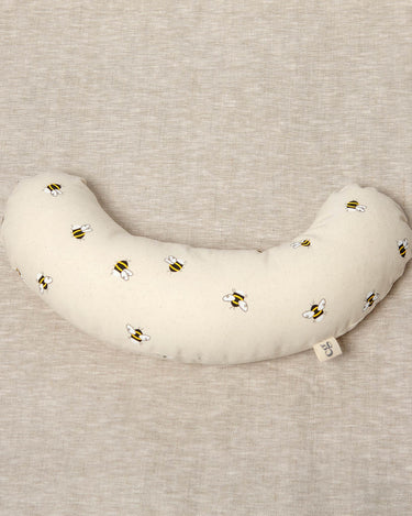 The Bee tummy time support aid helps newborn babies during their floor time. Made from a supportive wooden lining and a washable cotton cover. The fabric print has bees printed on it.