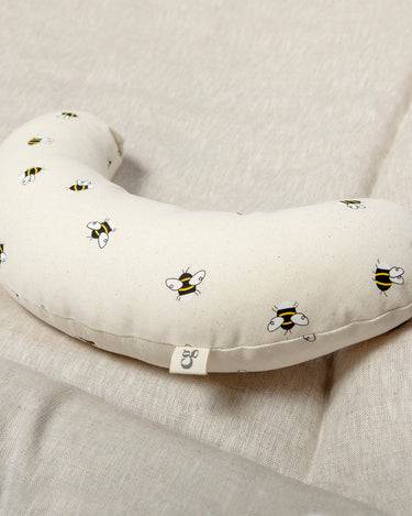 The Bee tummy time support aid is made from a supportive wooden lining and a washable cotton cover which helps newborn babies during their floor time.