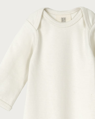 Organic cotton newborn sleepsuit in cream – GOTS certified – hospital bag essential baby gift – Babu - close up