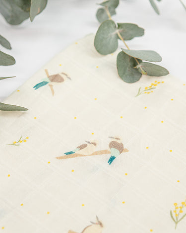 Organic cotton large muslin swaddle wrap in Australian native Kookaburra bird print – GOTS certified double gauze – newborn baby gift – baby essentials – Babu – close up with eucalyptus